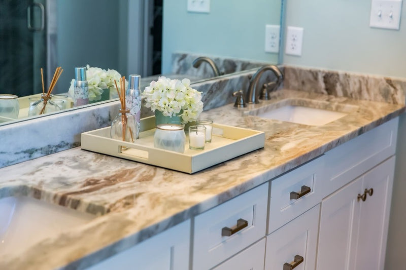 A sealed granite counter in a bathroom.