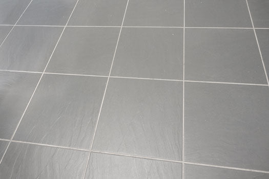 Cleaning grout image on natural stone.