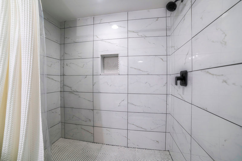 A shower showing how to clean grout.