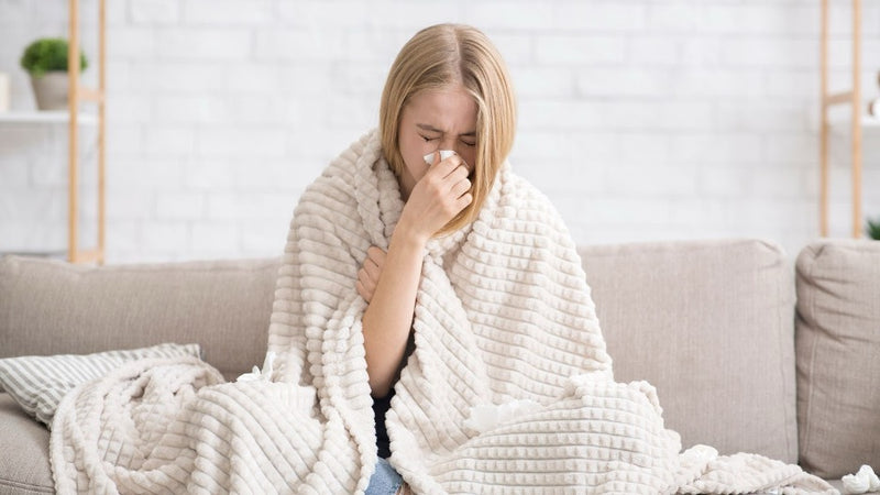 A person sneezing during cold season.