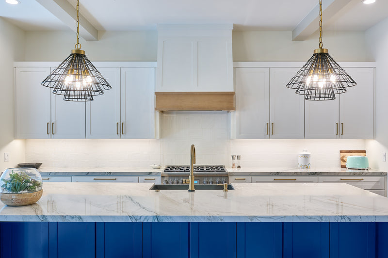 A kitchen with a clean counter and bright lights.