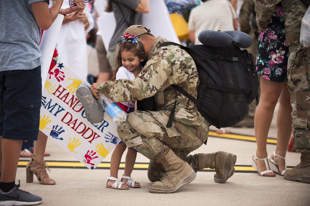 Soldier hugging his daughter